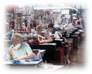 Image of women working in garment trade production line - 